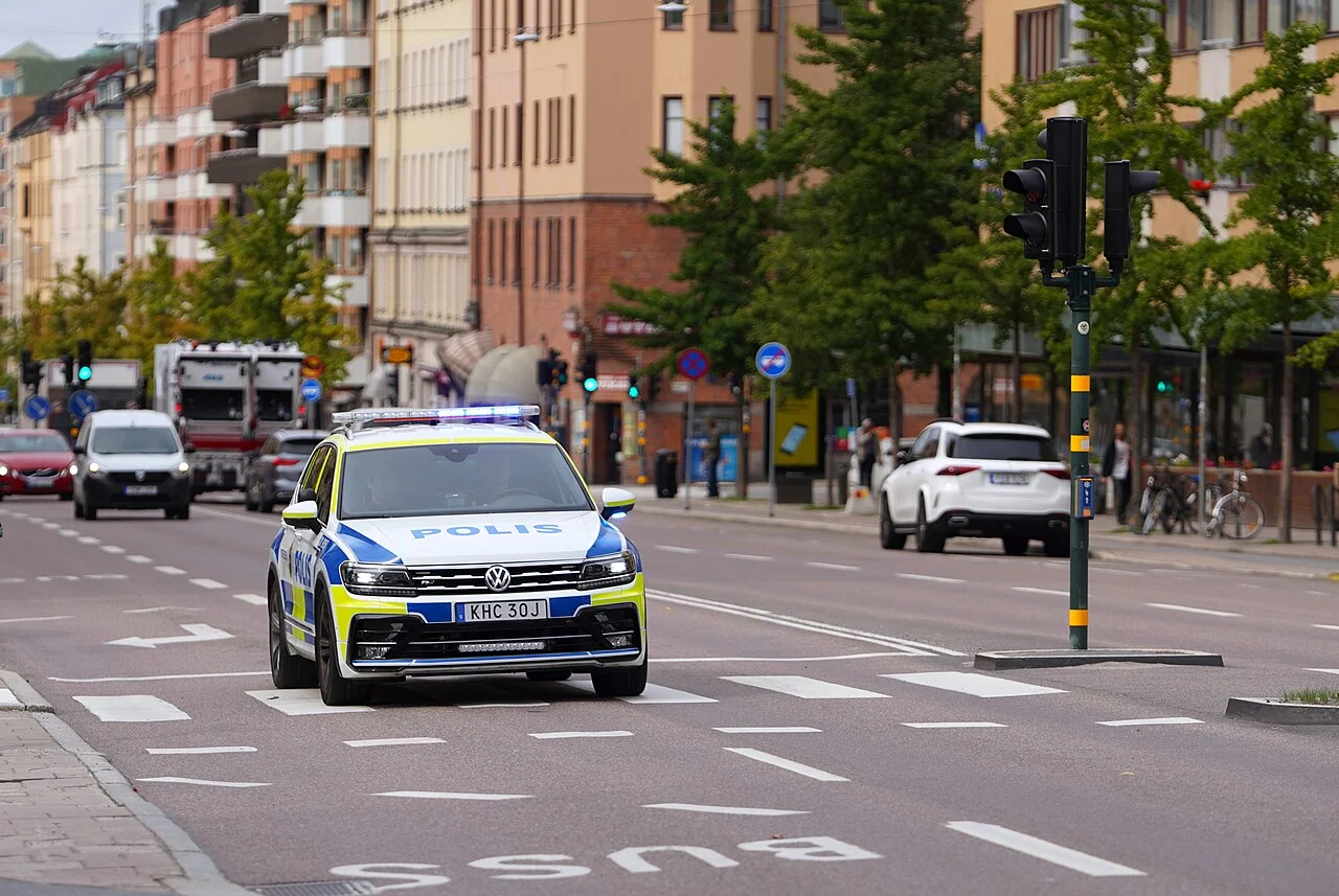 Police vehicle with emergency lights illuminated on a city street