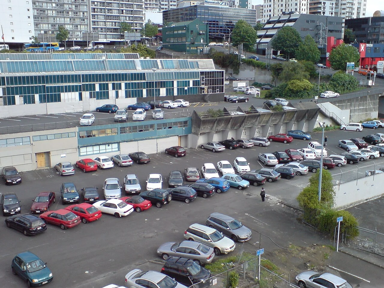 Open parking area beside industrial buildings