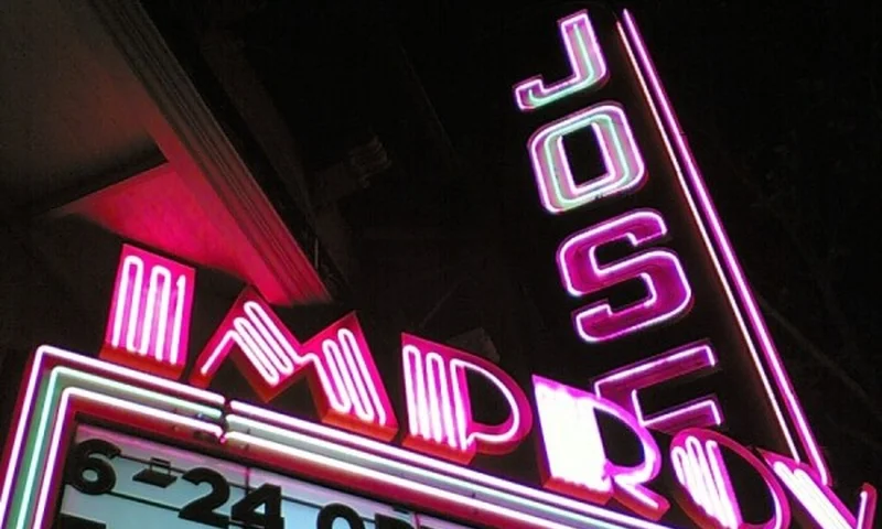 Neon Jose Theater and Improv signs in downtown San Jose at night